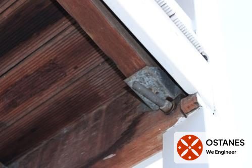 Metal bracket connecting balcony framing to a post