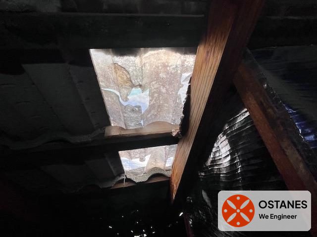 Broken skylight seen from inside a roof cavity above timber framing