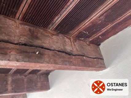 Split timber joist beneath a balcony