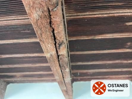Weathered and split timber joist on the underside of a balcony