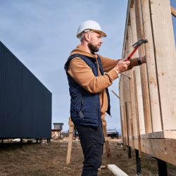 man-worker-hammering-while-building-wooden-frame-house-.jpg