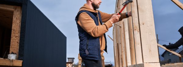 man-worker-hammering-while-building-wooden-frame-house-.jpg